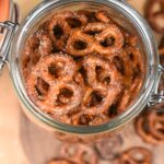 Sweet & Spicy Butter Toffee Pretzels Shown in a large glass jar with the lid open.