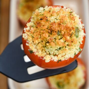 Stuffed Tomatoes Tomatoes Provençale Tomates a la Provensacale Shown oven baked tomatoes stuffed with goat cheese and bread crumb mixture. One lifted on a spatula.