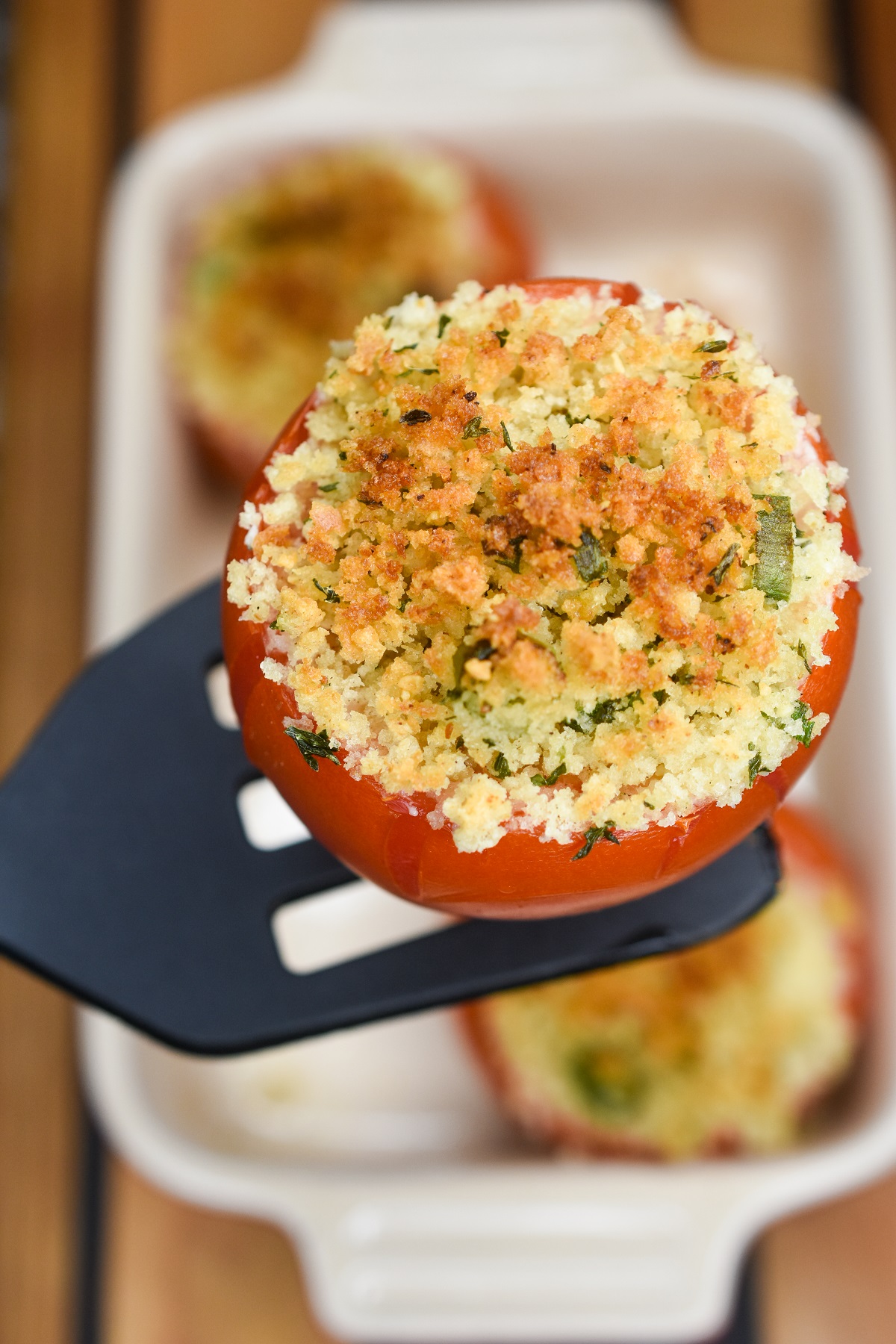 Stuffed Tomato baked topped with Panko on a spatula