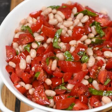 The flavor of this simple summer appetizer will blow you away! White Bean and Tomato Bruschetta. White Bean Dip with tomatoes.