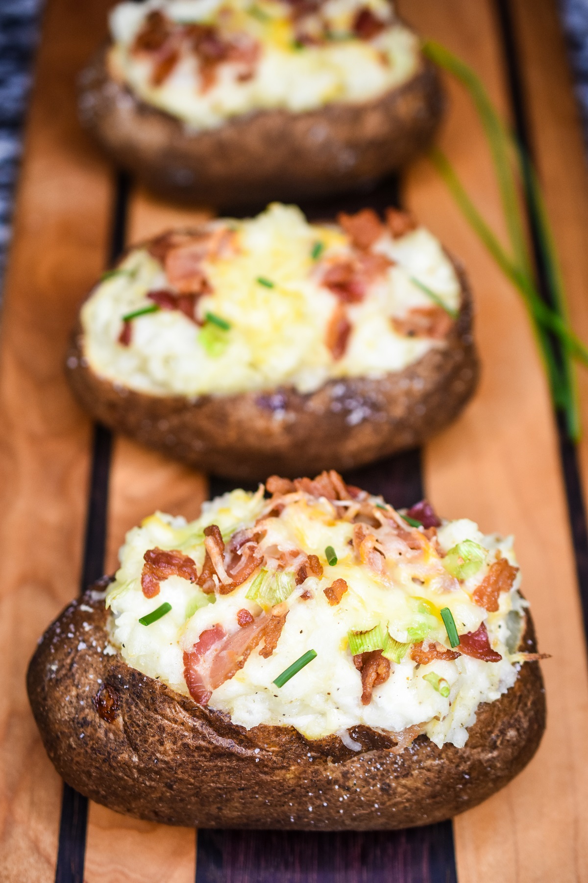 Twice Baked Potatoes are a fun and flavorful potato side dish recipe. A twice baked potato has a variety of add in options.