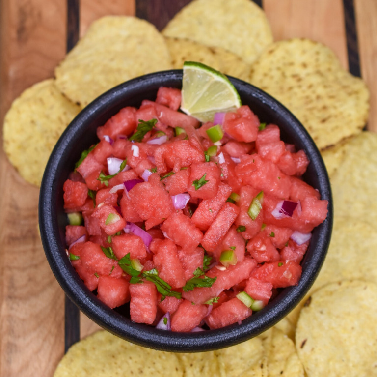 Watermellon Salsa recipe shown in a black bowl with tortilla chips.