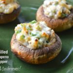 Grilled Mushrooms stuffed with Jalapeno Popper filling on a green plate