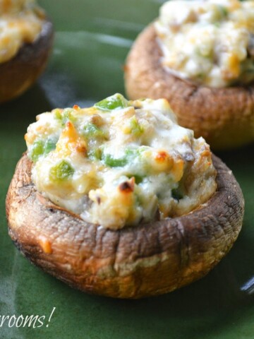 Grilled Mushrooms stuffed with Jalapeno Popper filling on a green plate