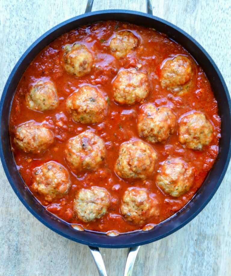 Chicken & Bacon Meatballs in a pan with tomato sauce. Recipe for chicken meatballs with bacon