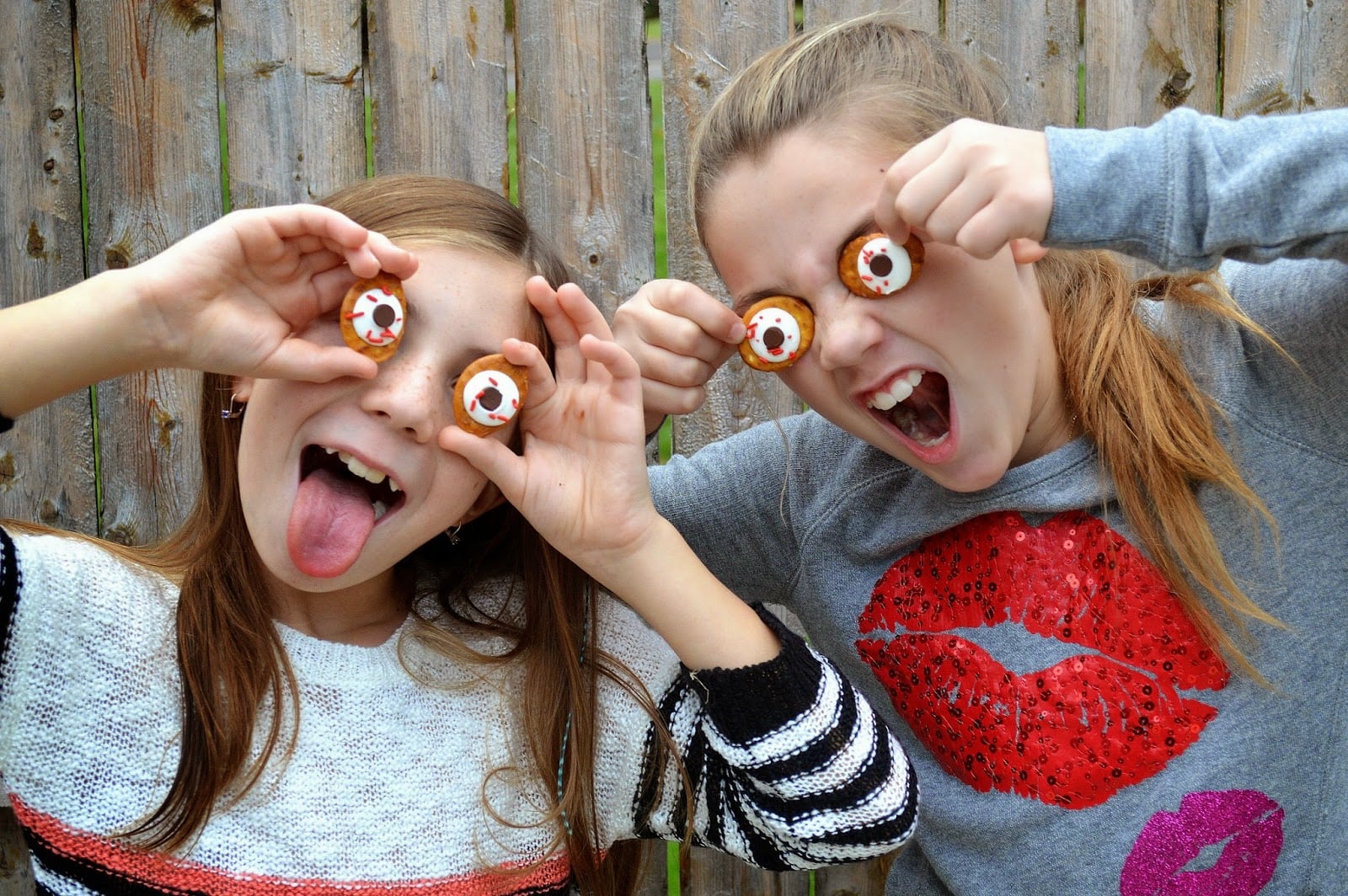 edible eyeballs for halloween 2 young girls holding up homemade pretzel eyes making silly faces