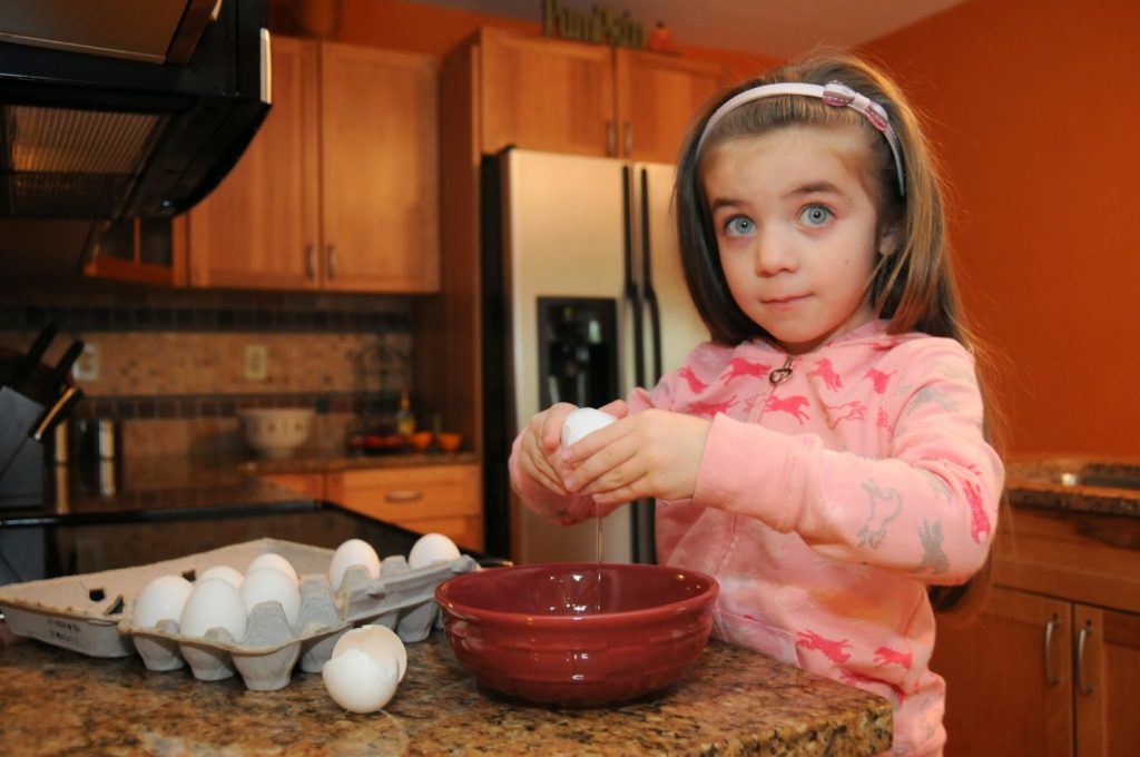 Little Girl Cracking Eggs