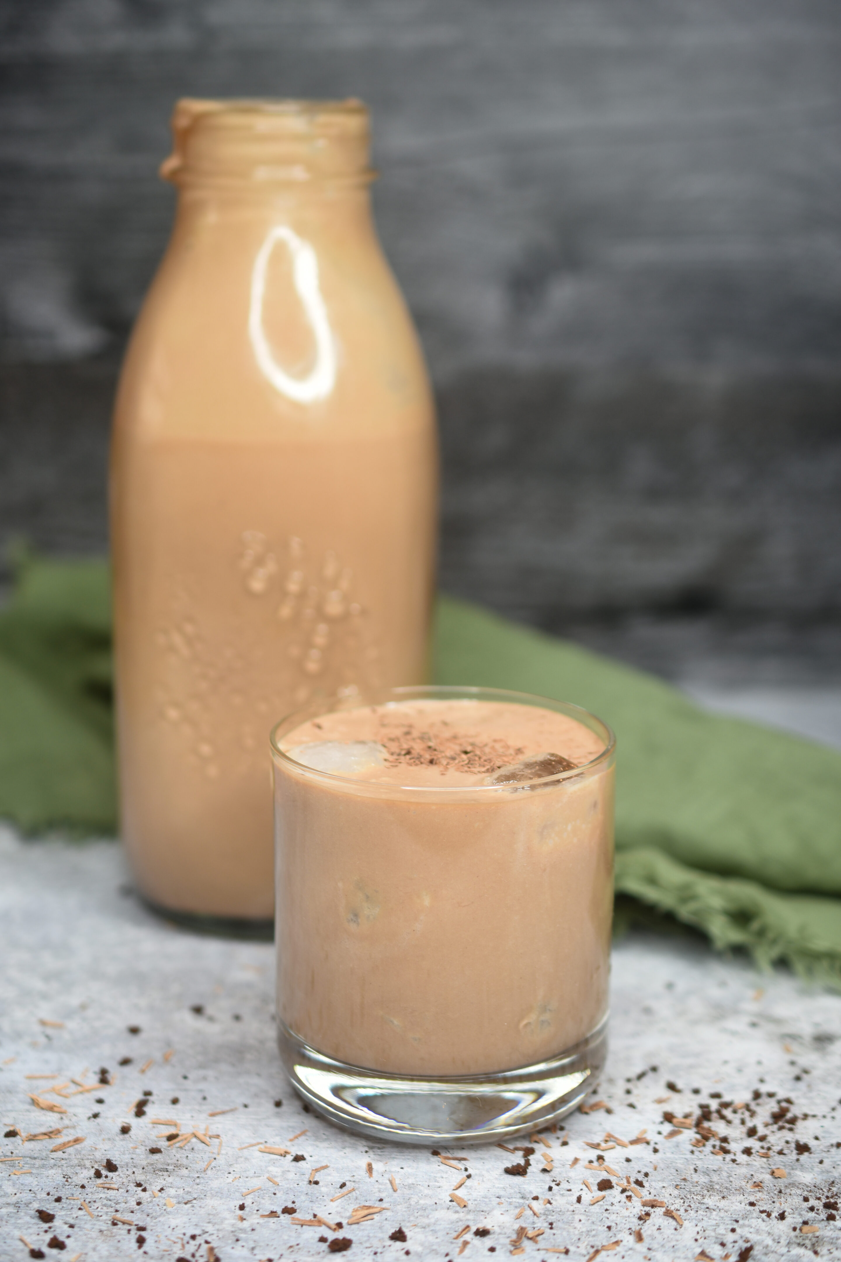 How To Make Homemade Irish Cream. Irish Cream Recipe. Shown is shot glass and in glass milk bottle.