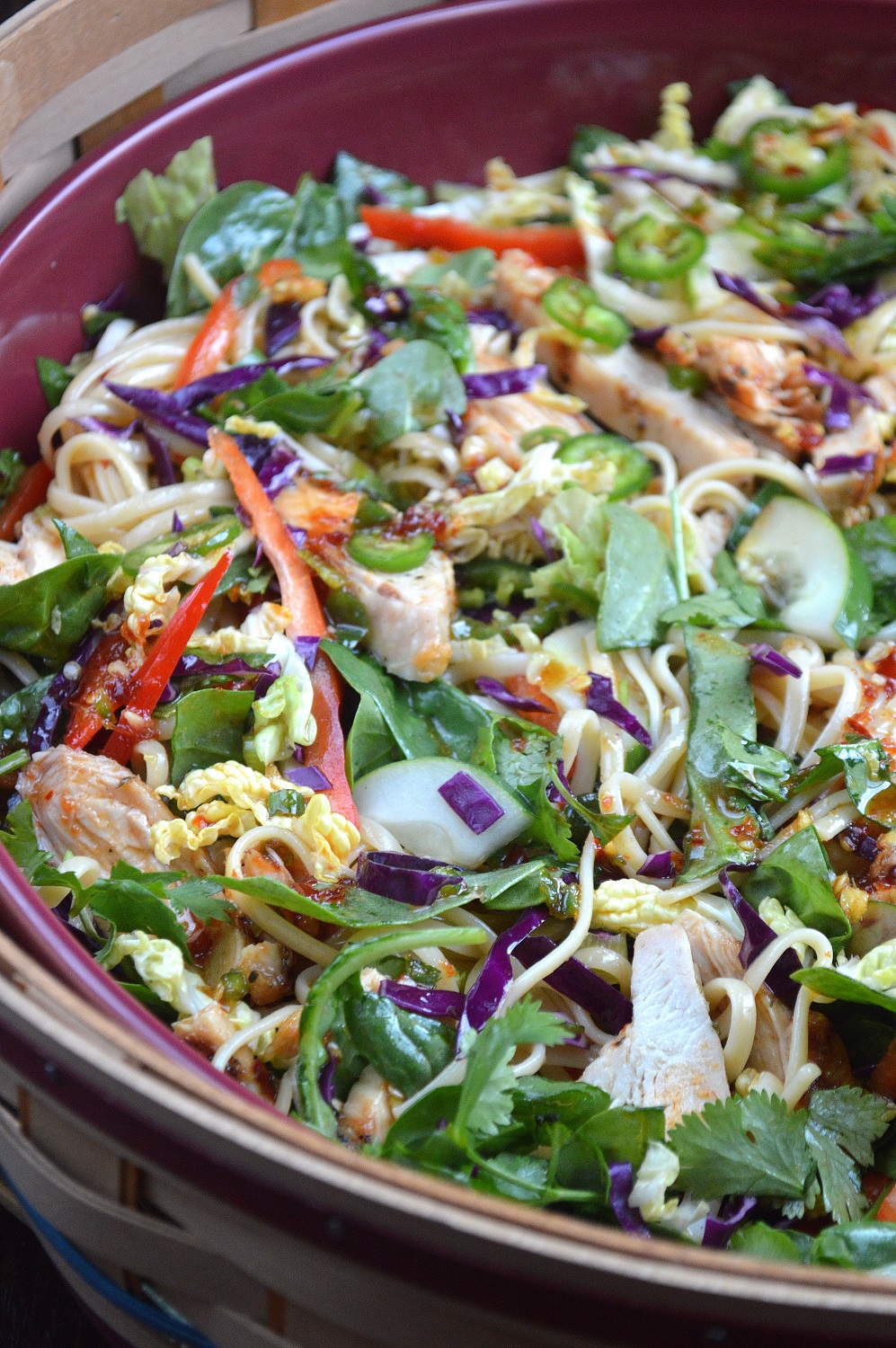 Asian Pasta Salad With Grilled Chicken SHown tossed Asian Salad with grilled chicken, noodles and numerous vegetables.