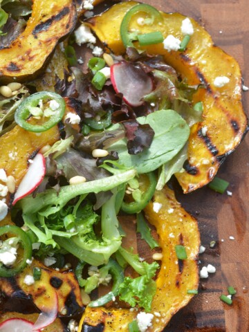 Grilled Acorn Squash Salad With Jalapenos, Fets Cheese and Pine Nuts and a Honey Lemon Vinaigrette