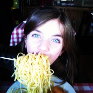 Girl eating pasta and loving it