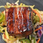 Slow Roasted Pork Belly Bites over Jalapeno Slaw.