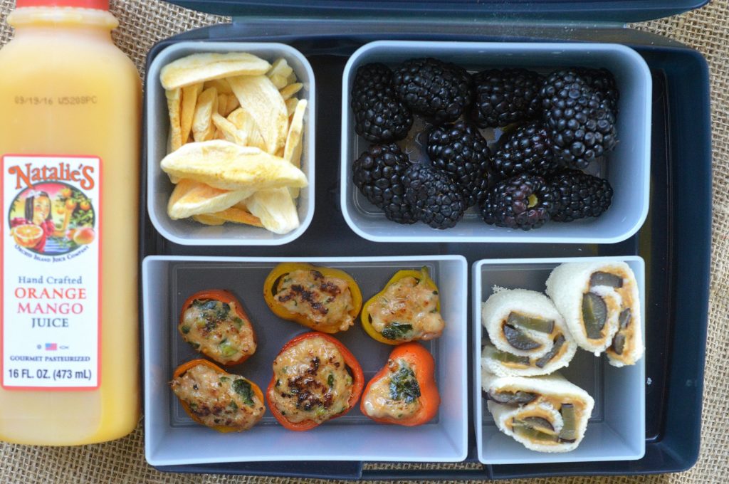 Lunchbox idea for school Pepper Rings Stuffed with Chicken Sausage, PB & Grapes Roll Ups, Blackberries, Mango Chips and Natalies Juice