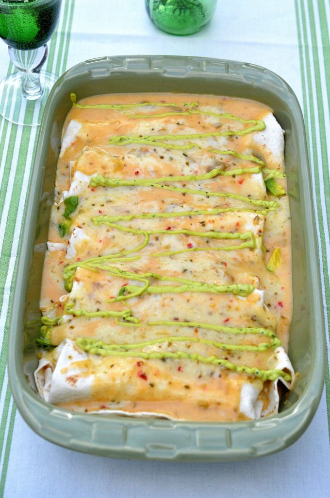 Spicy White Chicken Enchiladas with Avocados and a Spicy Creamy Guacamole Cream Drizzle