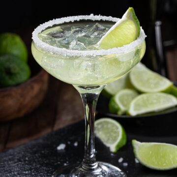 Pitcher Margarita Recipe shown in a glass with salt rim and lime wedge