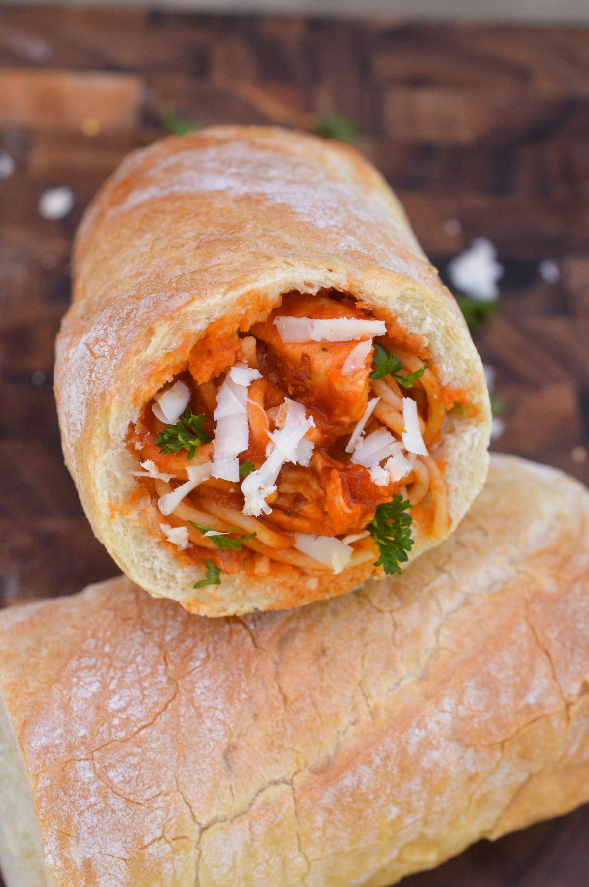 Homemade Pasta Pockets. Stuffed Bread with pasta and sauce. Shown French bread that was hollowed out and filled with spaghetti and sauce garnished with herbs and cheese.
