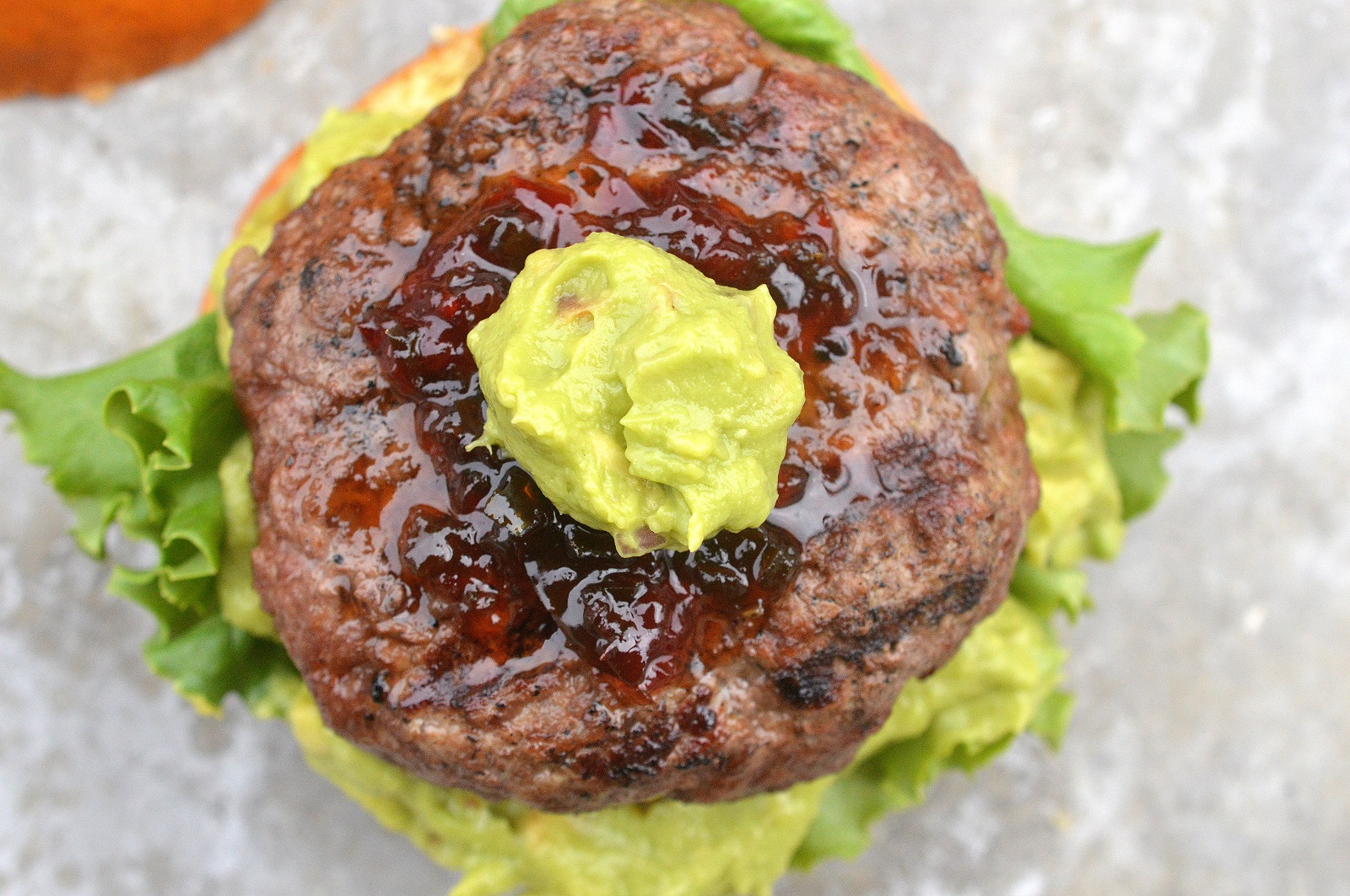 Guacamole Burgers. Creamy guac and the sweet & spicy kick of hot pepper jelly make these dairy-free burgers irresistible!