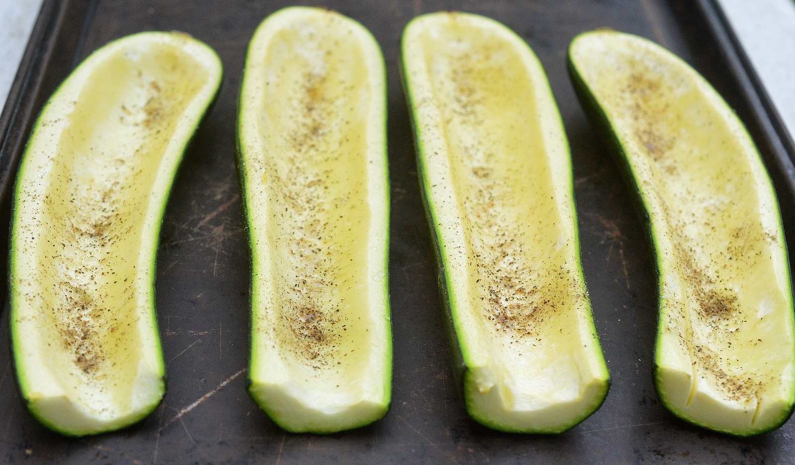 Prepping zucchini for Sausage, Pepper, Onion, Tomato and Cheese Stuffed Zucchini