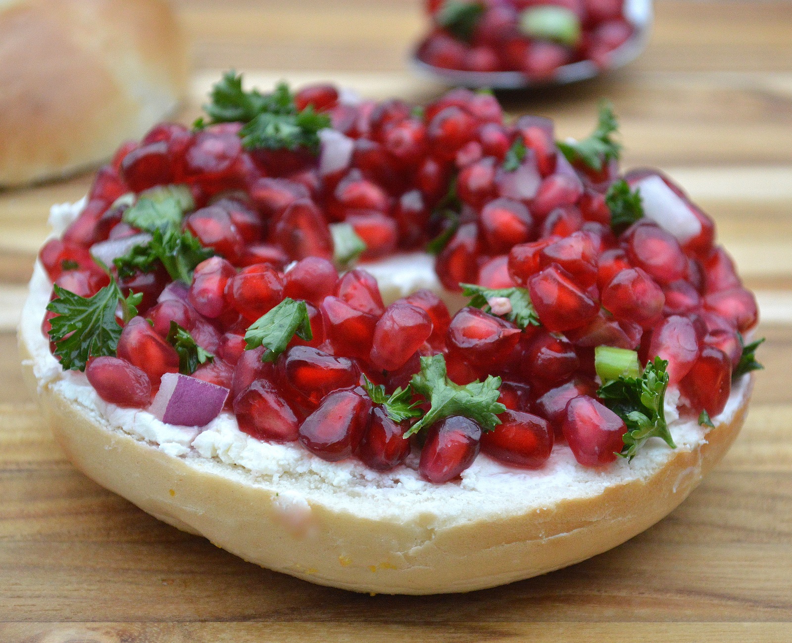 Christmas Brunch recipe idea. Thanksgiving Breakfast food. Festive bagels topped with pomegranate seeds and cream cheese are fun and delicious! 