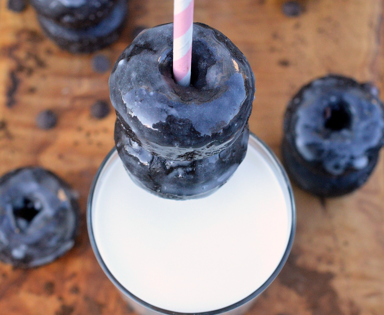 Easy to make Glazed Chocolate Donut Recipe. Pictured chocolate donuts over a glass of milk.