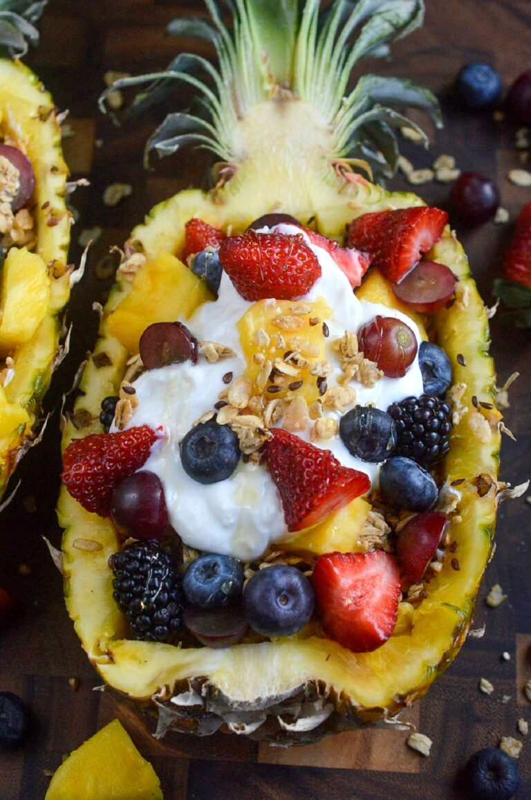 Stuffed Pineapple Yogurt Parfait, this is the best breakfast recipe! It's so delicious! Yogurt, fruit, granola and more in a pineapple bowl.