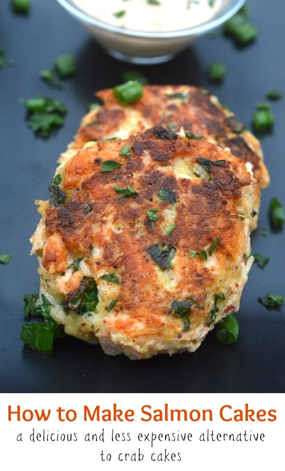 Image of two cooked salmon cakes on a plate with tartar sauce.