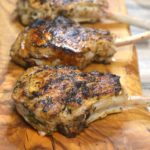 The BEST Grilled Veal Chops Recipe Shown Grilled Veal Chops on a wooden board.