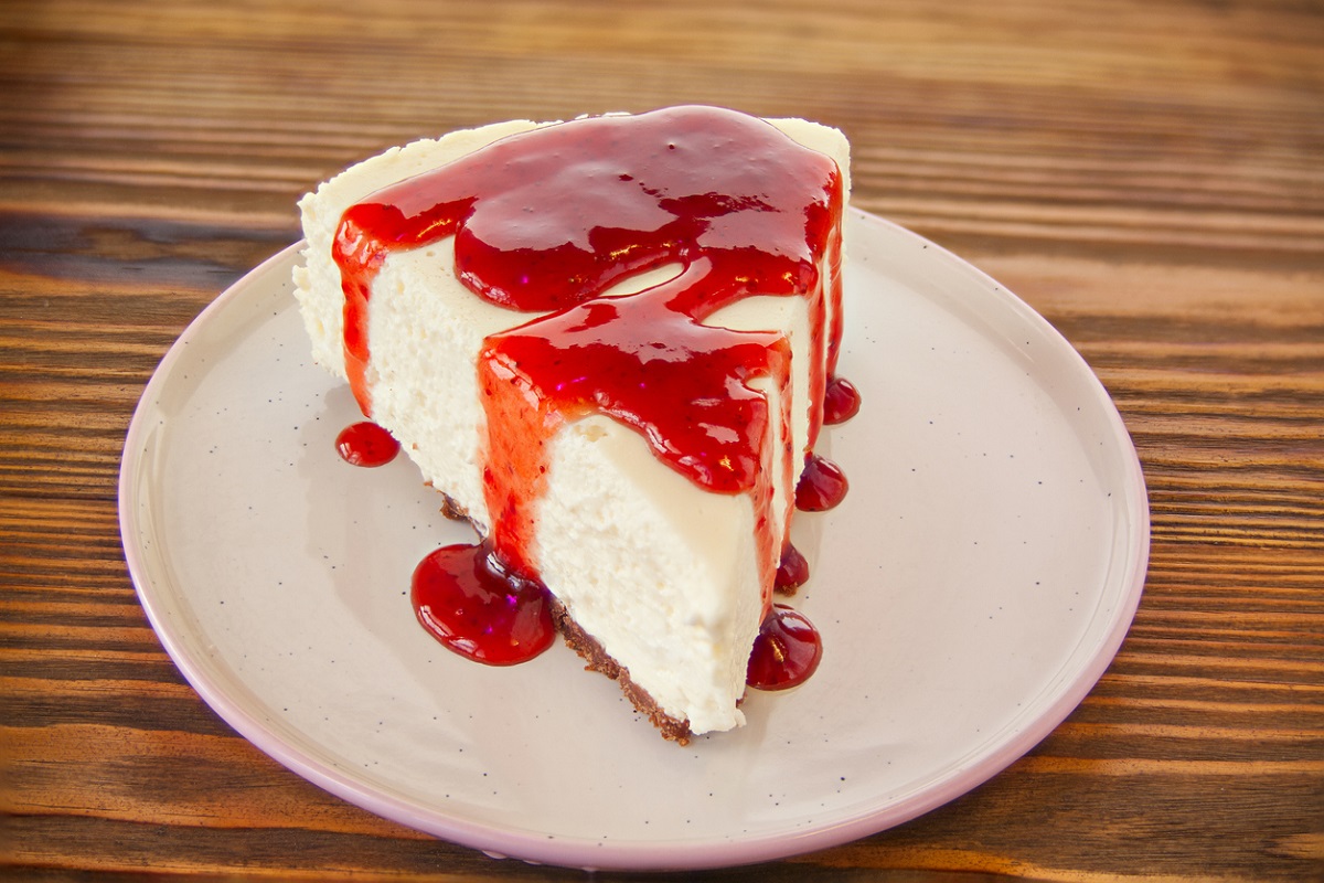 Slice of cheesecake with strawberry puree topping. cheesecake topping ideas