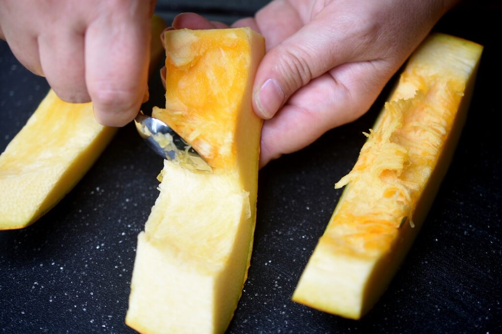 How to roast pumpkin for soup, scraping off the pulp before roasting.