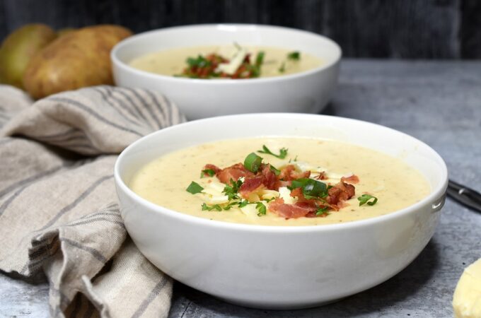 Creamy Potato Soup topped with bacon crumbles in a white bowl