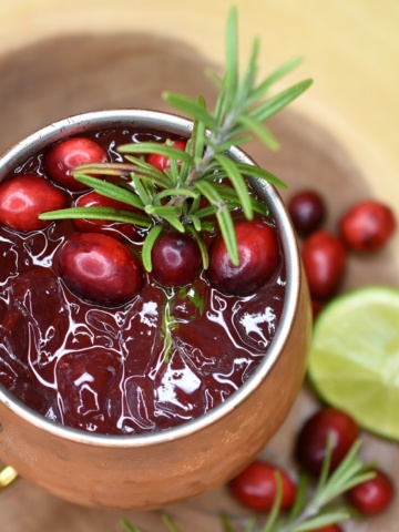 Cranberry Moscow Mule cocktail in copper mug