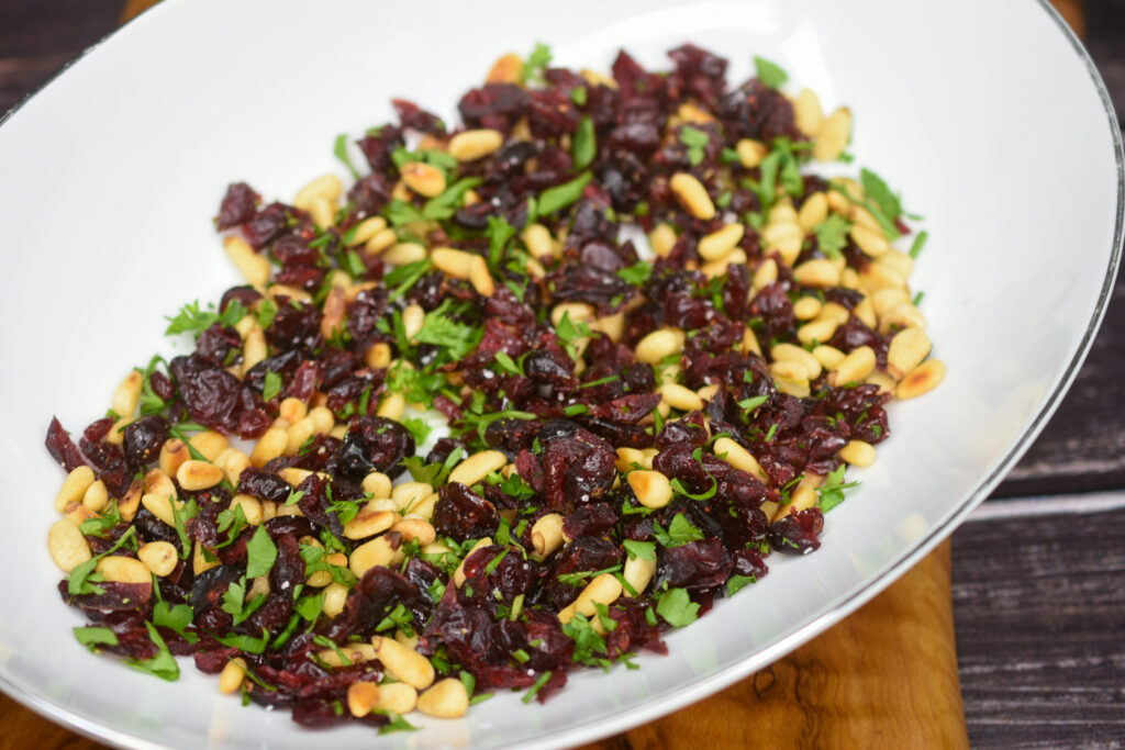 dried cranberries, pine nuts and fresh herb mixture for goat cheese appetizer
