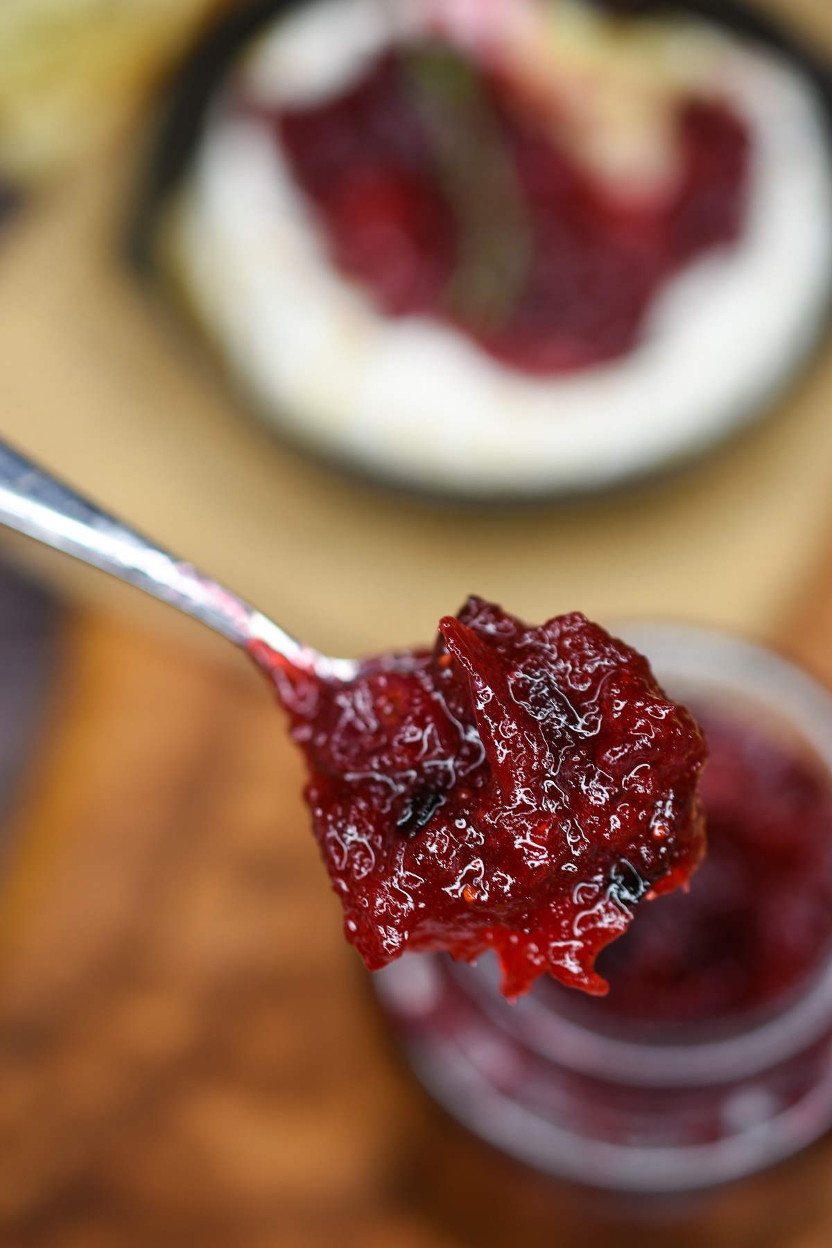 Homemade Cranberry Jam recipe. An easy & delicious holiday recipe. Shown Cranberry Jam on a spoon.