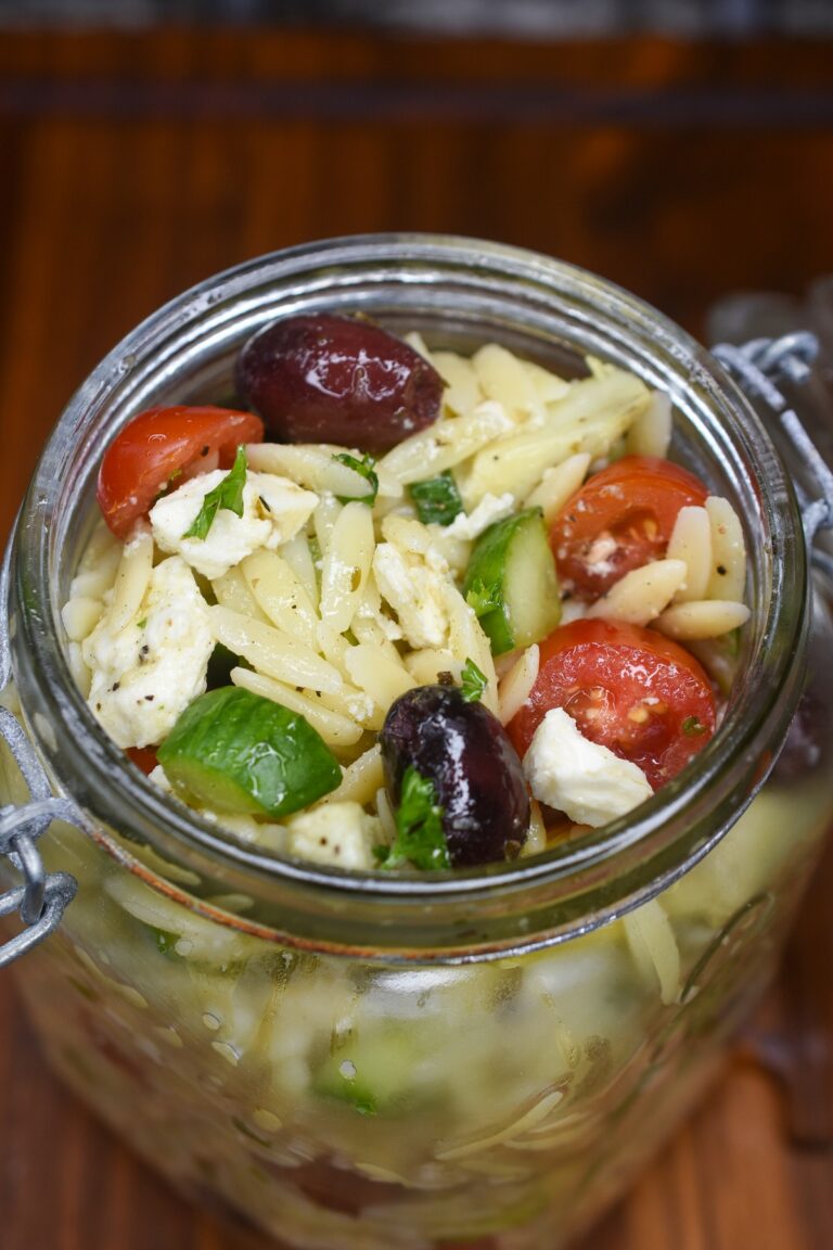 Greek Orzo Salad Medeteraniean pasta salad with tomatoes, feta, cucumbers and artichokes