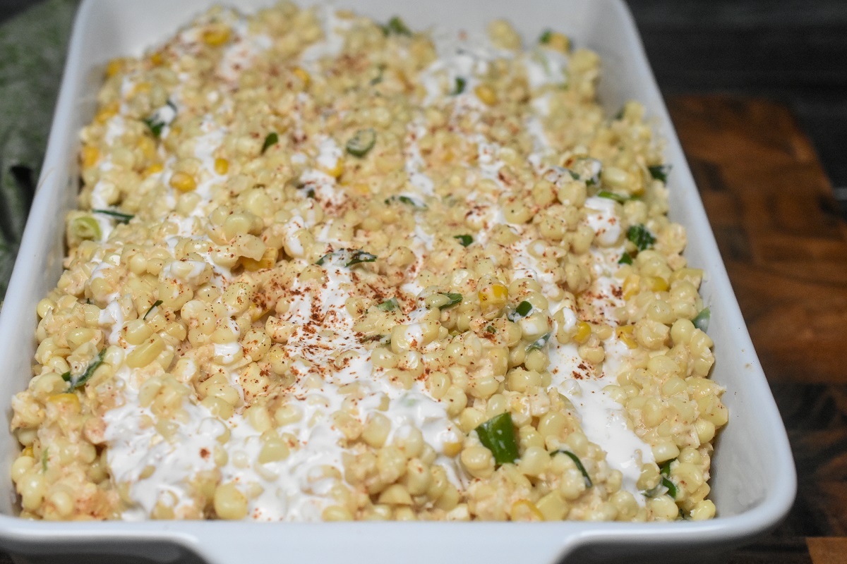 Mexican Street Corn Casserole can also be used as a Mexican Street Corn Dip shown in a white casserole dish