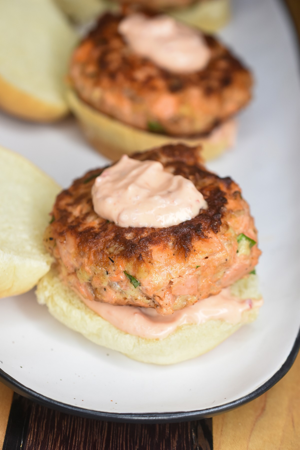 Salmon Sliders with Sriracha Mayo on an open faced roll