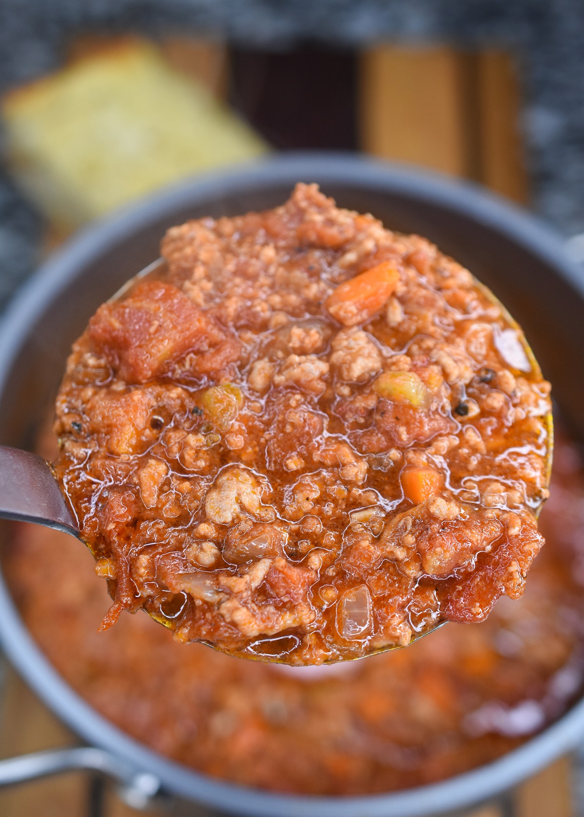 Ladle of homemade Bolognese sauce for pasta