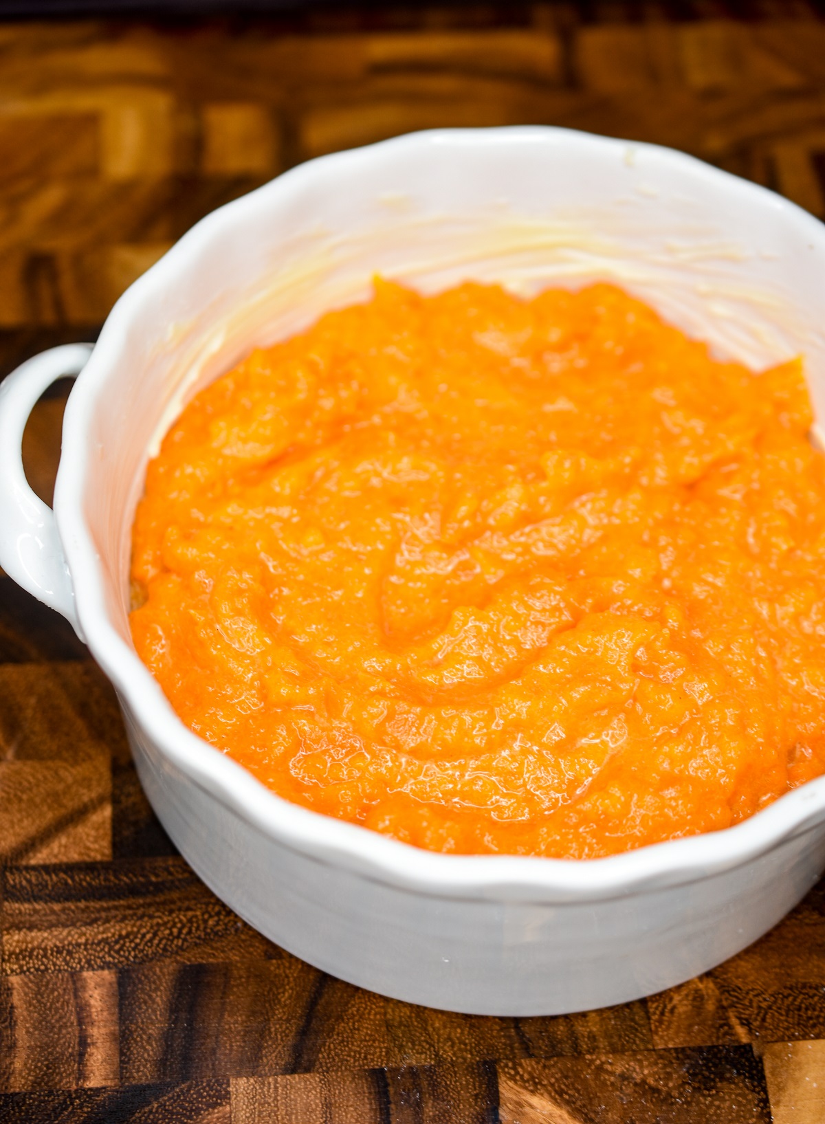 Carrot Souffle, ready to bake in the oven Shown batter for the dish in a white baking dish.