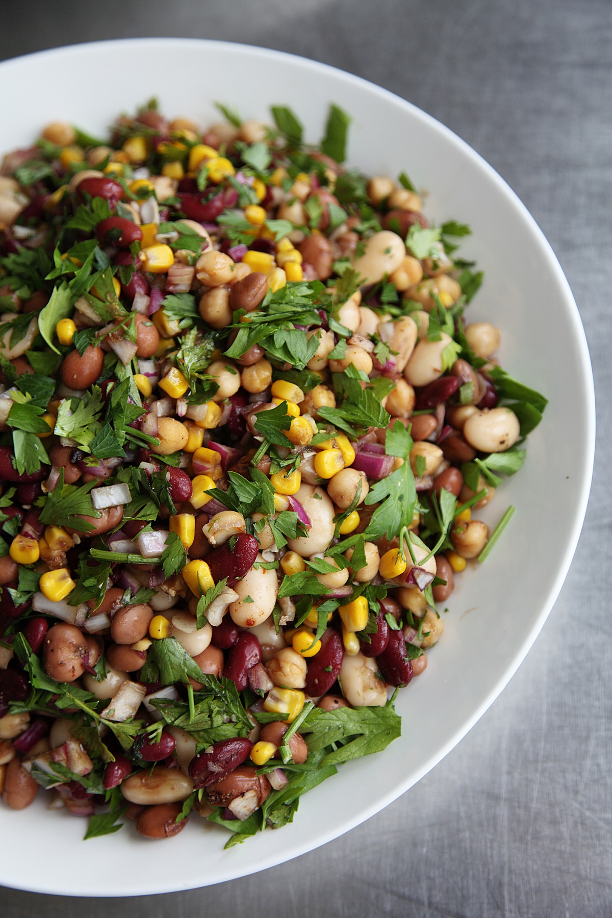 Dens Bean Salad Variations, shown here 4 varieties of beans in salad with corn, parsley and onion