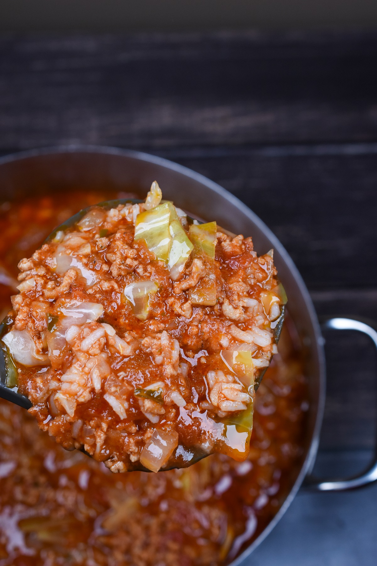 Golumpki Soup Recipe also called Unstuffed Cabbage Soup. SHow on a ladle over a large pot.