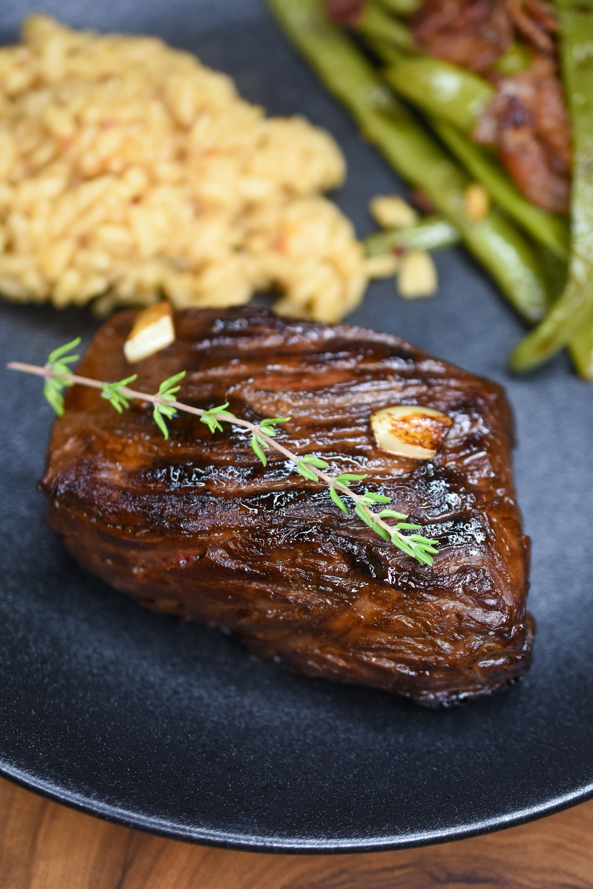 Bavette de Boeuf known as Bavette Steak in America. Also called Flap Steak is a delicious cut of beef. Shown cooked bavette on a plate with farro and vegetables.