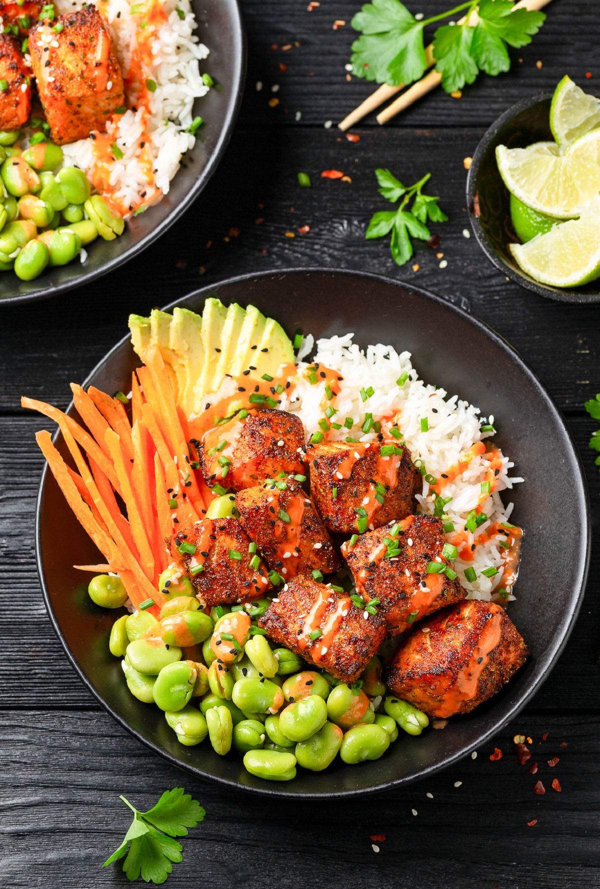 Blackened Salmon Rice Bowl such a quick, easy and satisfying meal. Shown salmon bites over rice with carrots, edamame and avocado