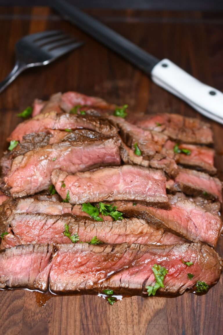London Broil Marinade. Slices of cooked London Broil Steak with marinade.