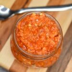 This easy to make Chili Garlic Sauce is the secret of so many delicious recipe! Plus its a great way to use those red jalapeno peppers from the garden! Homemade Chili Garlic Sauce shown in a mason jar