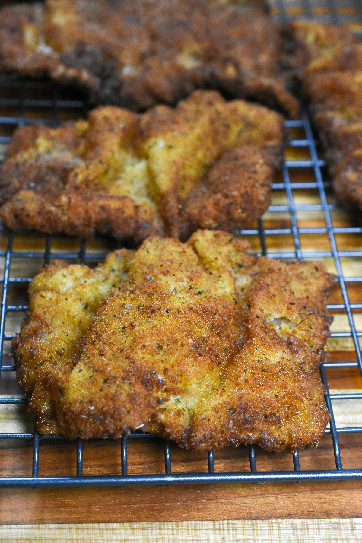 Weiner Schnitzel, shown cooked resting on a wire rack.