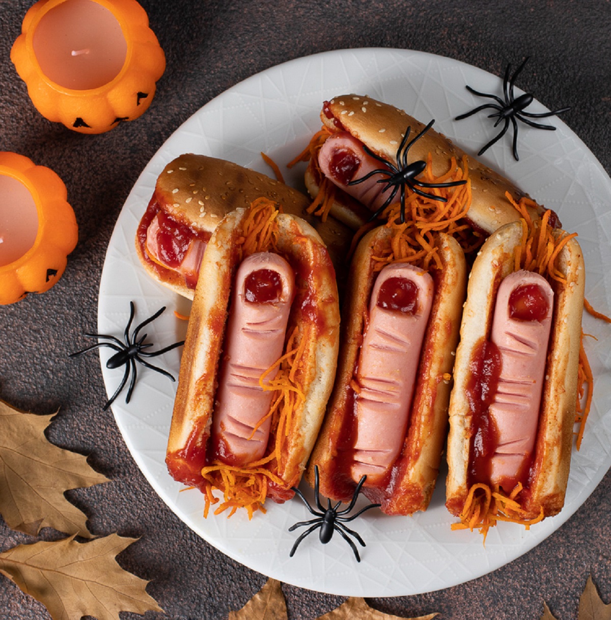 Halloween recipe for Finger Dogs. Shown hot dogs on a roll cut to look like bloody fingers (garnished with ketchup)